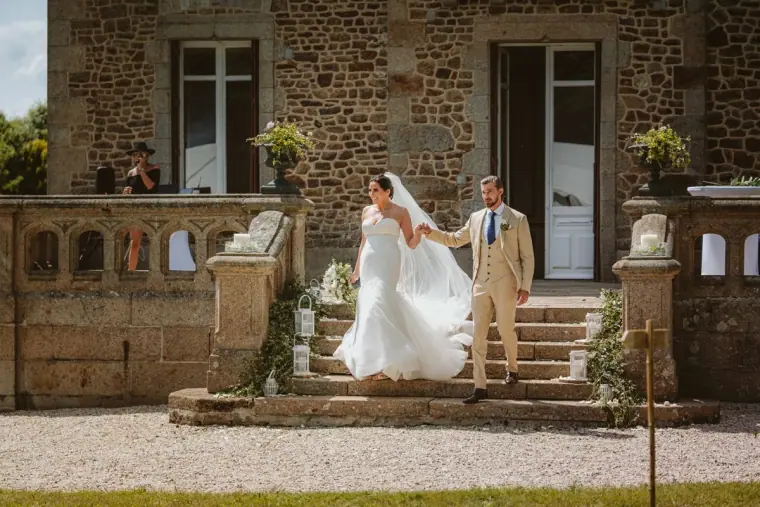 Lauren and Josh on the stone steps of the château entrance