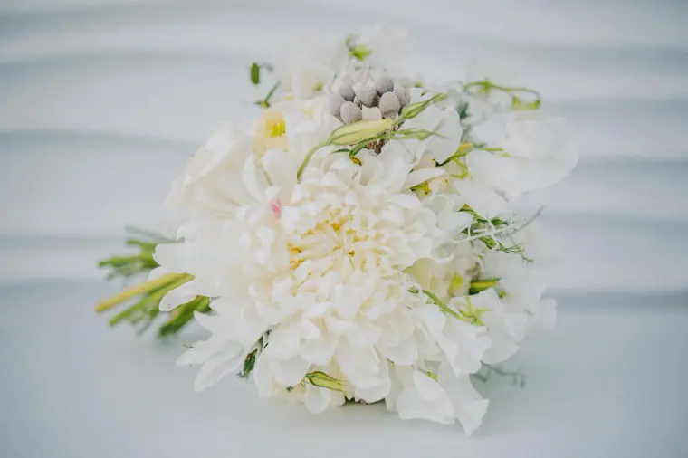 White bridal bouquet of dahlias, roses and silver brunia