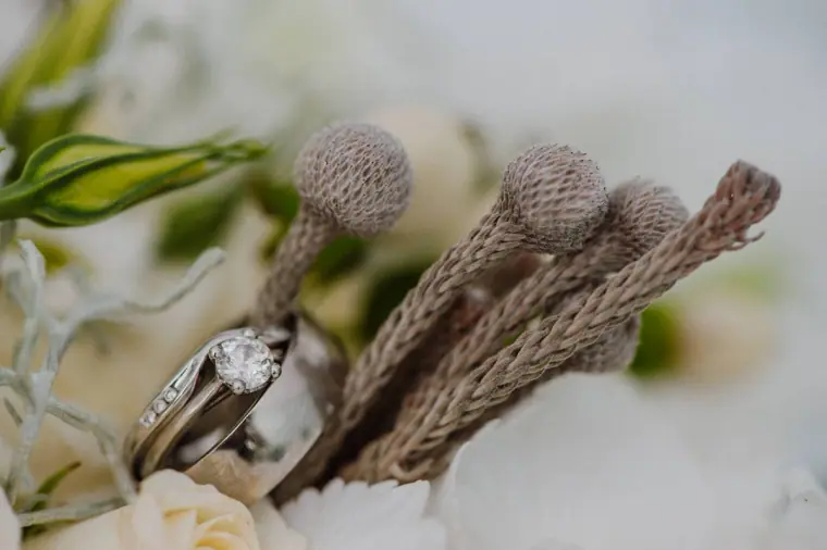 Wedding rings resting among silver brunia in the bouquet