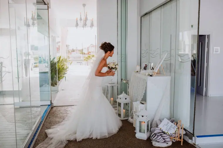Louise in her full-skirted gown in the bright white Galu Seaside interior