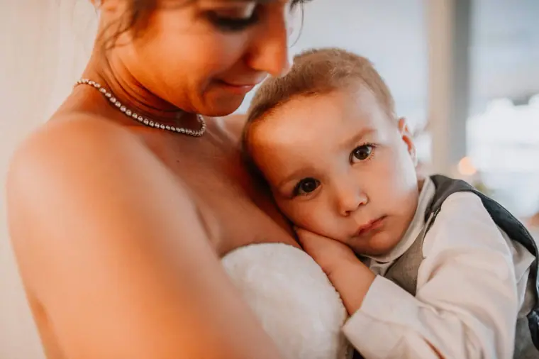 Louise cuddling the young pageboy in his waistcoat