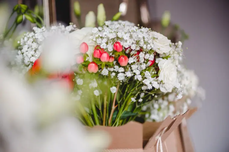 Bouquets of gypsophila and red roses waiting in gift bags