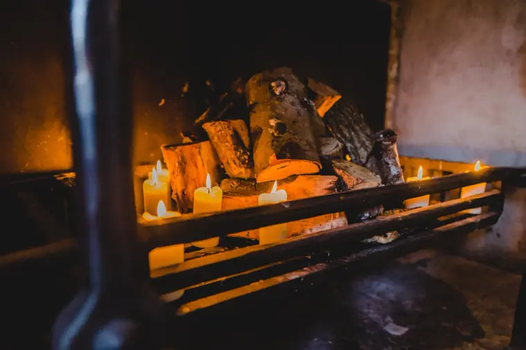 Log fire with candles burning in the stone hearth