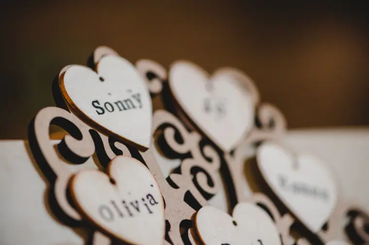Laser-cut wooden heart place names stacked together