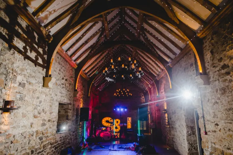 Band set up beneath the vaulted roof with the S&J letters lit in red and blue