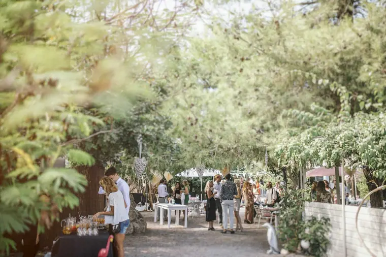 Leafy garden walkway filled with guests before the ceremony