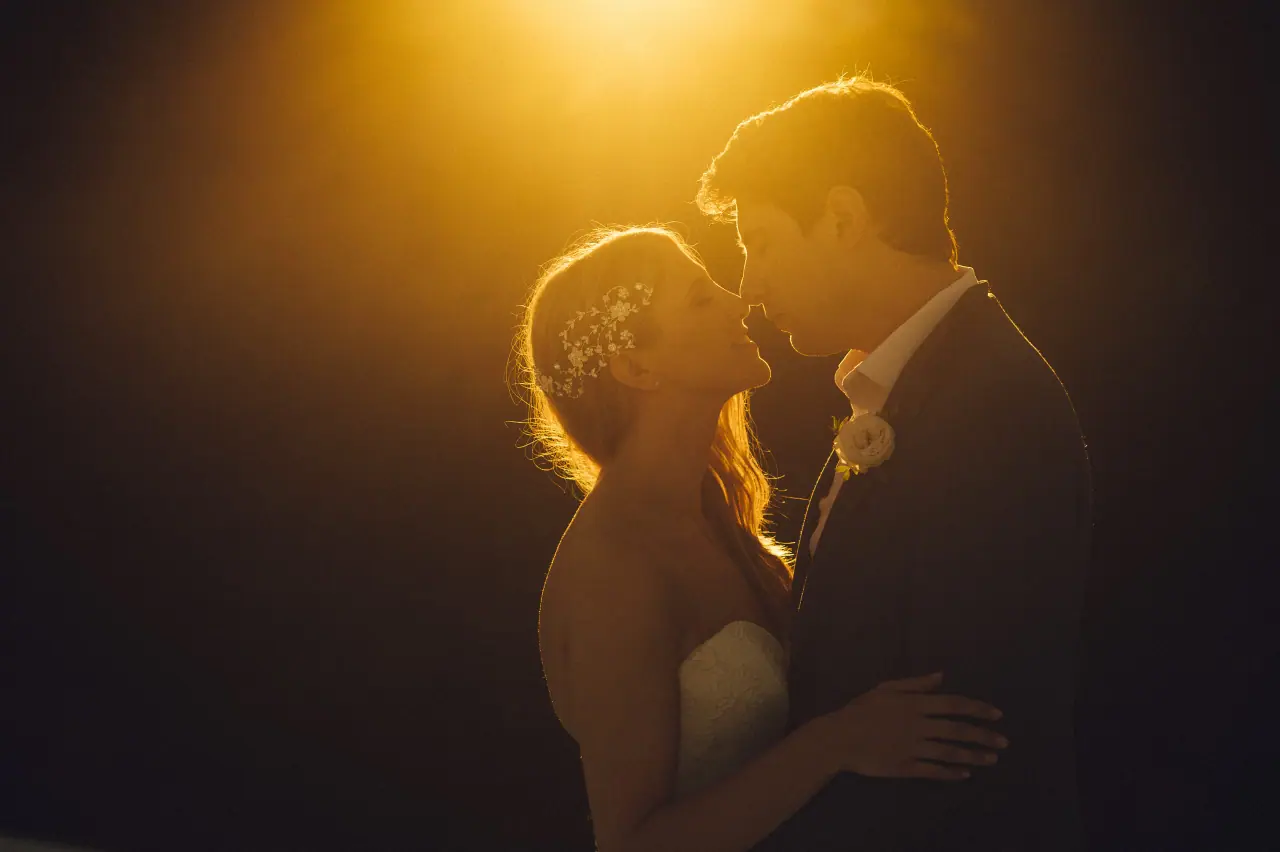 Bride and groom kissing in warm golden backlight in Ibiza