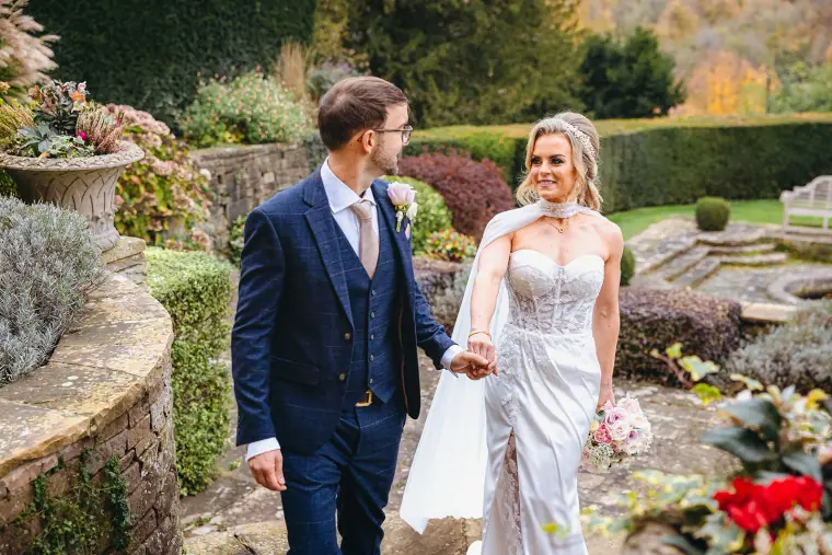 Ian and Jade walking hand in hand through the terraced gardens at Hedsor House