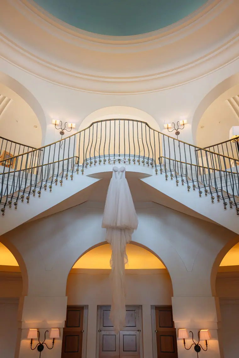 Sweeping twin staircase beneath a domed ceiling at Anassa Hotel