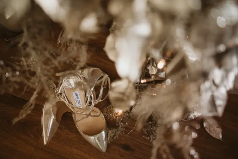 Bridal heels and a crystal hairpiece among silver dried flowers