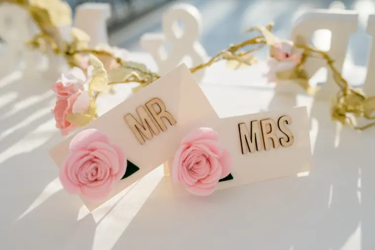 Mr and Mrs signs with pink roses on the top table