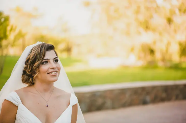 Nermine smiling in soft golden light, her veil framing her face