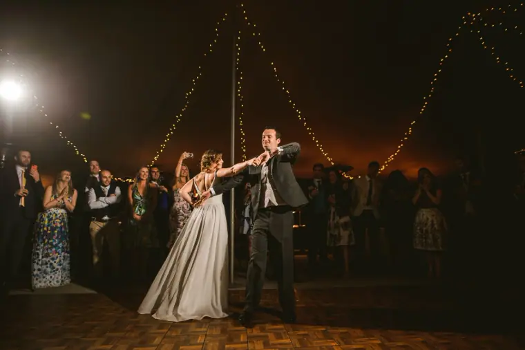 Nermine and Christopher's first dance under strings of fairy lights in the tent