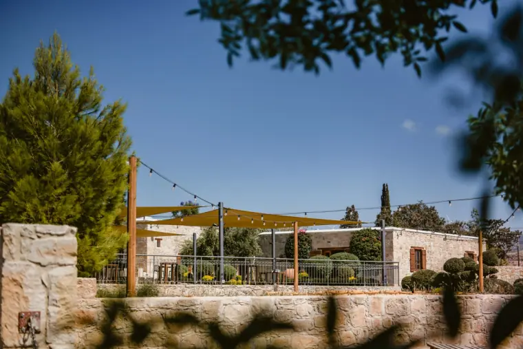 Stone terrace with festoon lights and shade sails at Liopetro, Kouklia