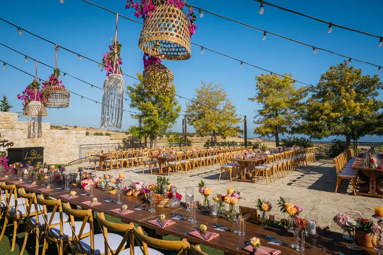 Reception tables with pampas grass and hanging macramé lanterns at Liopetro, Kouklia