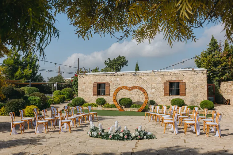 Ceremony chairs facing a giant wooden heart on the lawn at Liopetro, Kouklia