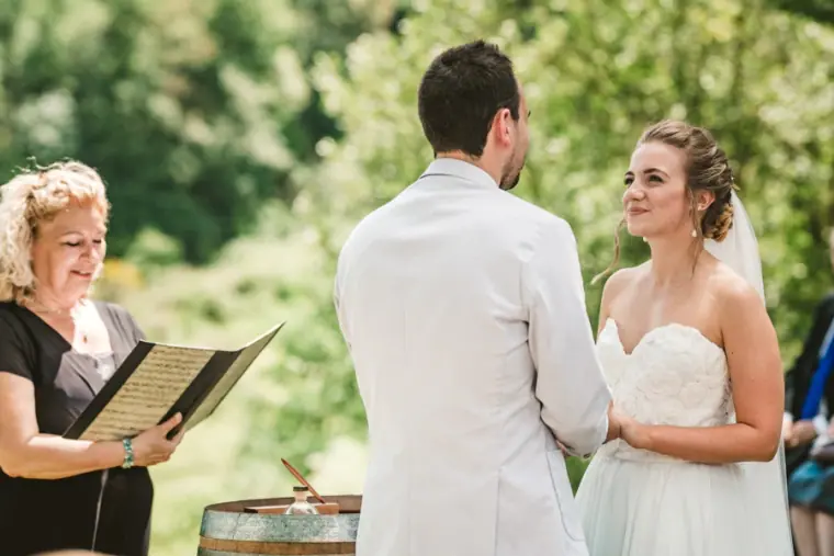 Bride smiling at her groom as the celebrant reads during the ceremony