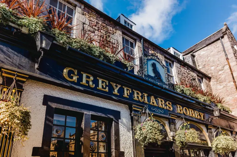 Greyfriars Bobby pub sign with hanging flower baskets, Edinburgh