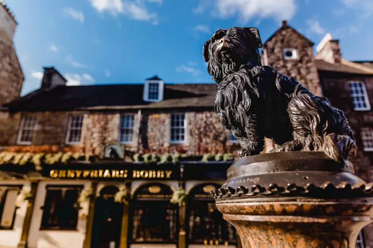 Bronze Greyfriars Bobby statue in front of the Greyfriars Bobby pub, Edinburgh