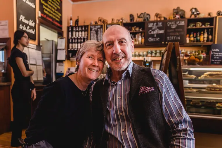 Smiling older couple posing together inside an Edinburgh café
