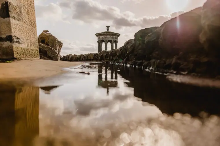 Dugald Stewart Monument reflected in a rain puddle on Calton Hill