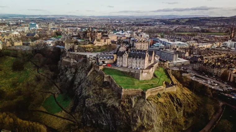 Aerial view of Edinburgh Castle and the city stretching to the horizon