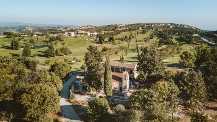 Aerial view over the green golf course and hills of Minthis Hills, Paphos