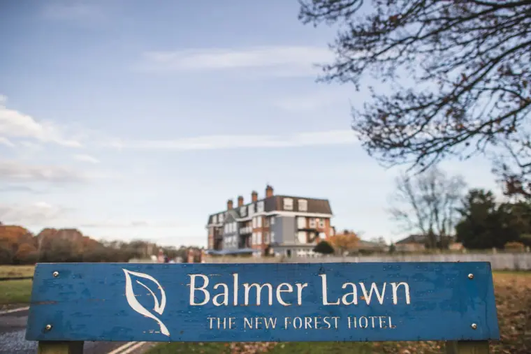 Balmer Lawn, The New Forest Hotel sign in front of the hotel on a sunny day