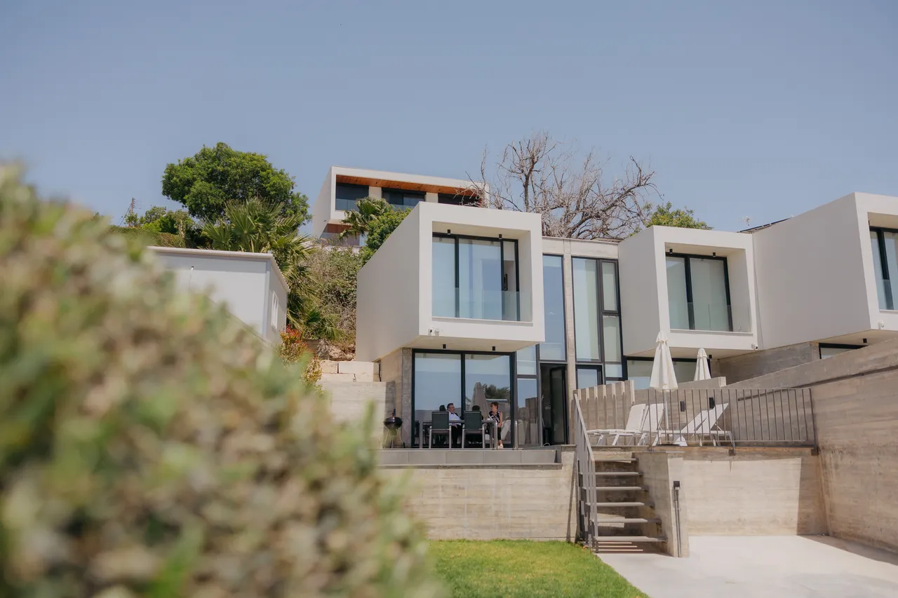 Modern hillside villa with a terraced lawn on the morning of Olivia and Ashley's wedding