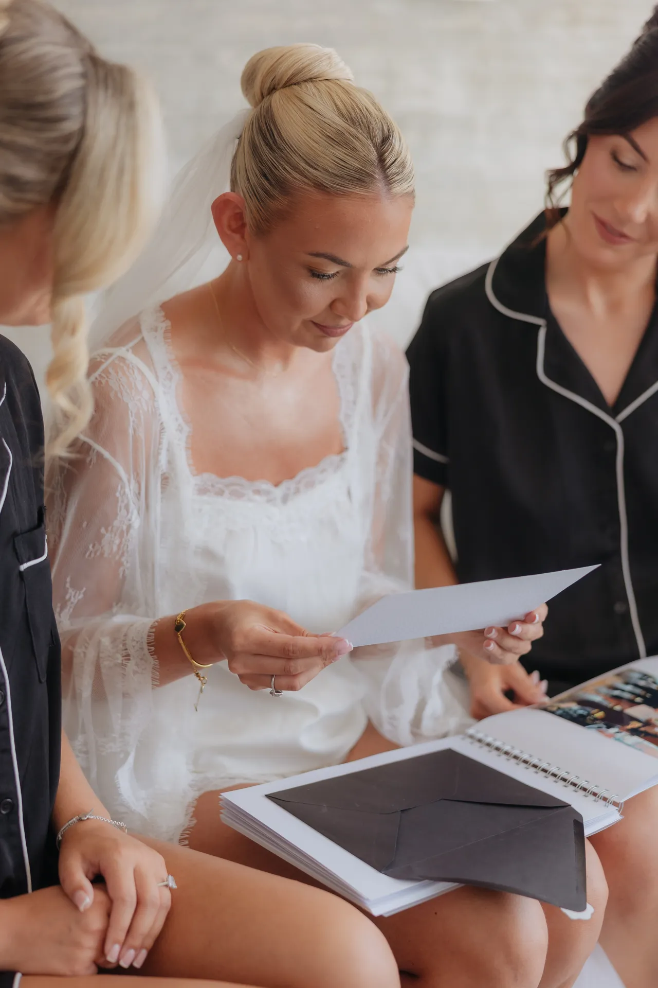 Bride reading a card from her bridesmaids while getting ready