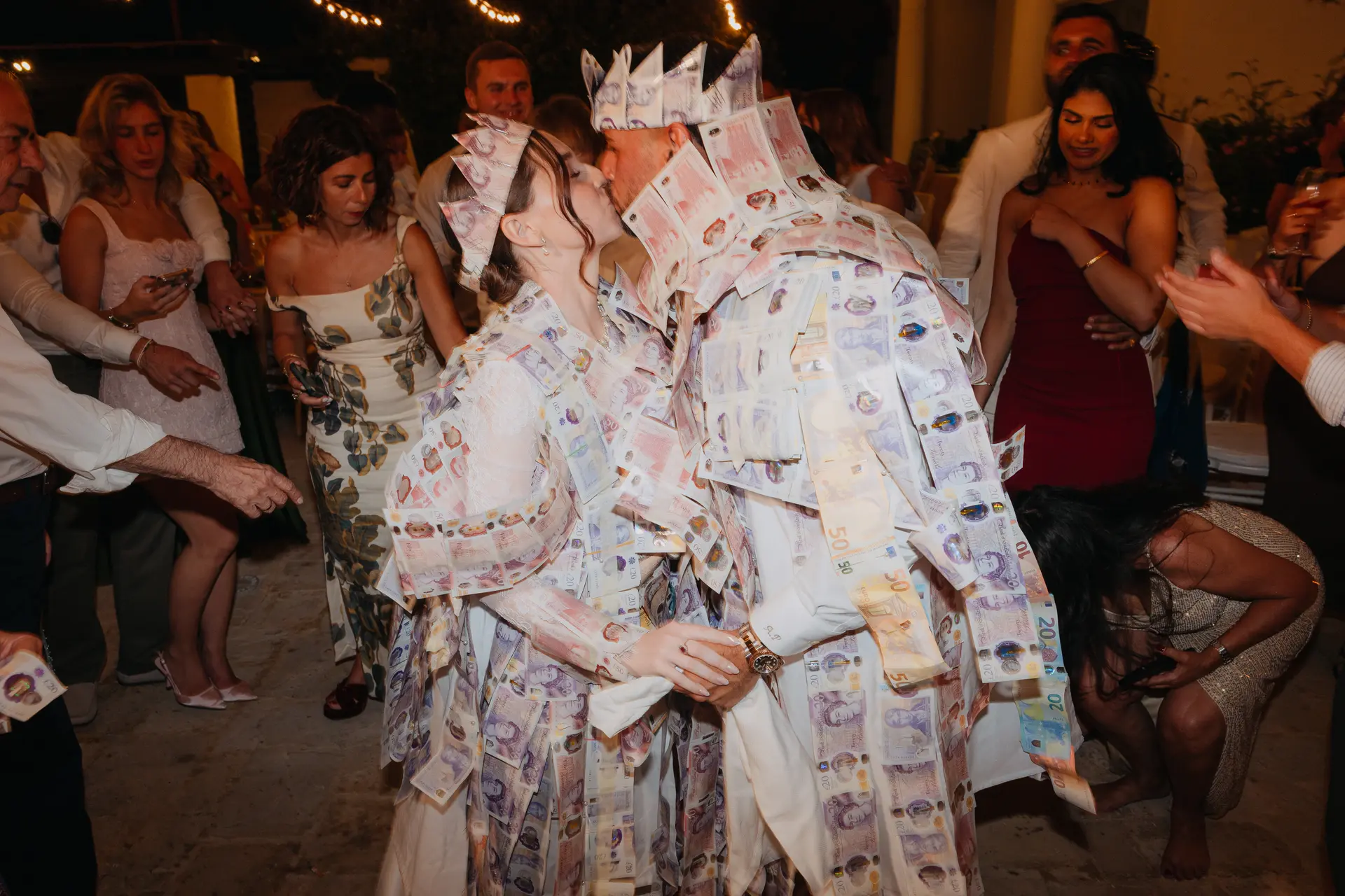Poppy and Andrew covered in banknotes during the traditional money dance