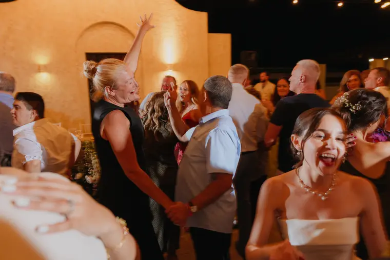 Guests dancing and laughing together at the evening reception