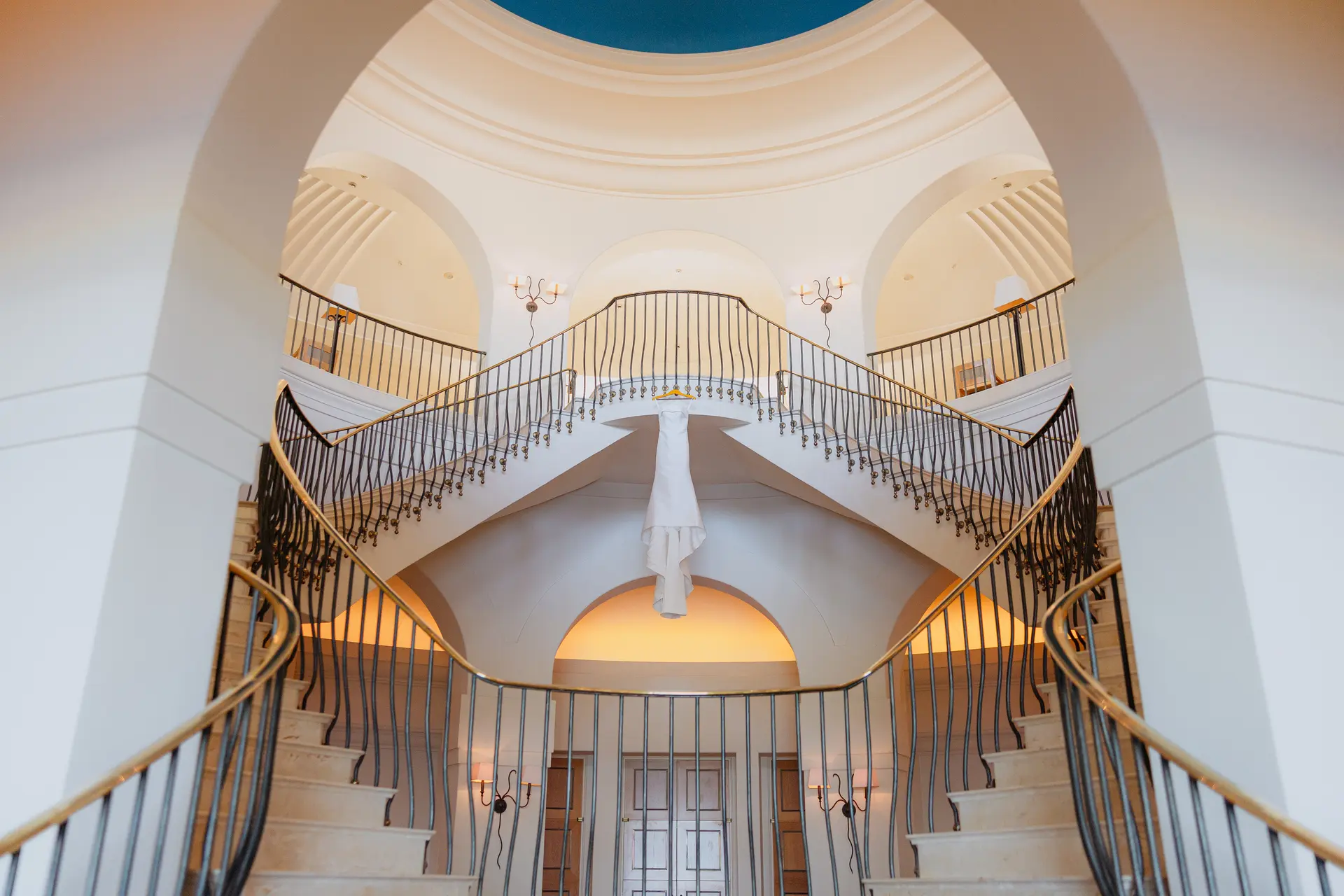 Wedding dress hanging beneath Anassa's domed double staircase