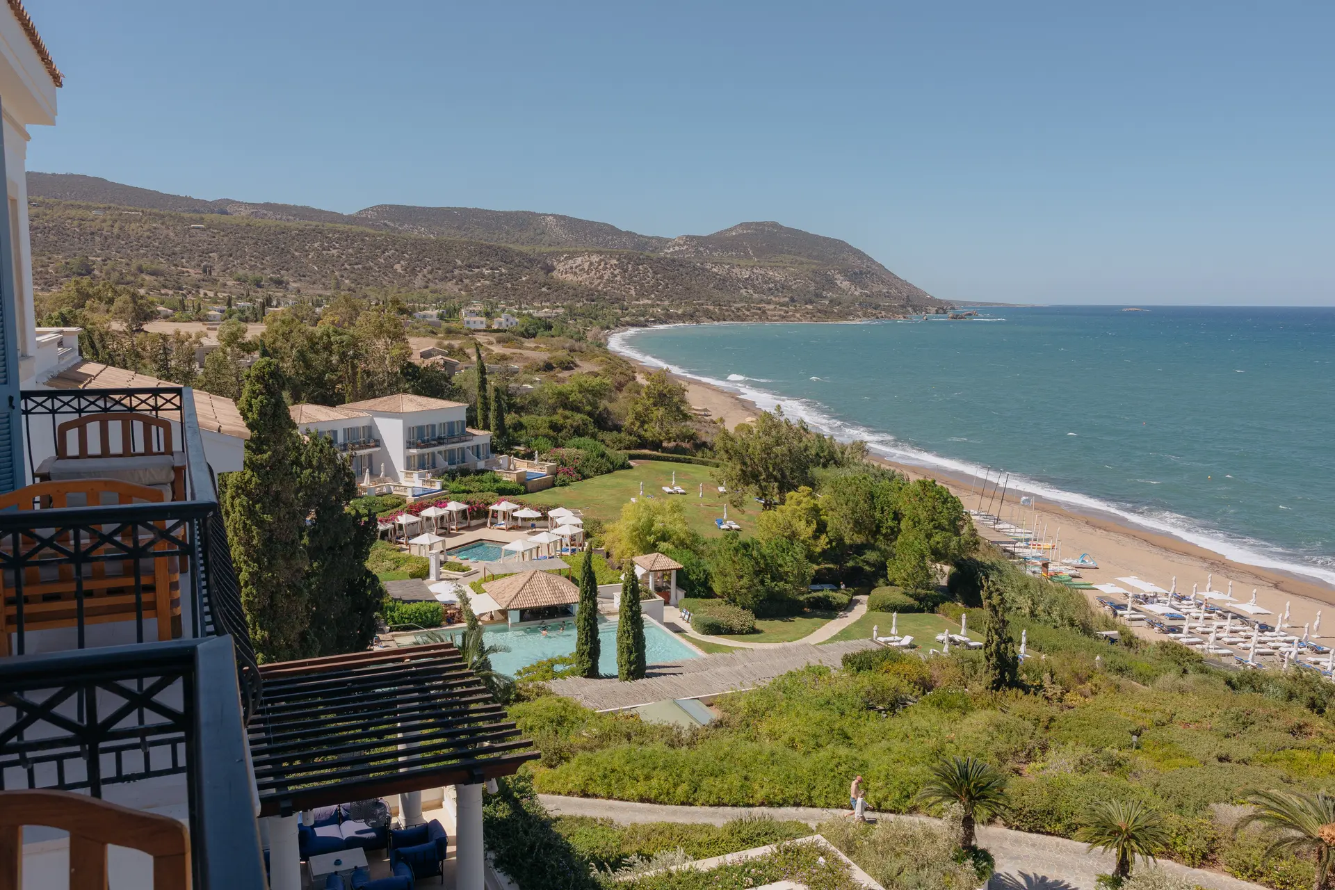 Balcony view over Anassa's pools and gardens to the sandy beach and sea