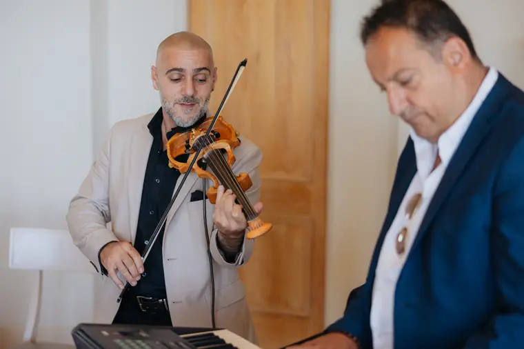 Violinist playing indoors during the morning's traditions