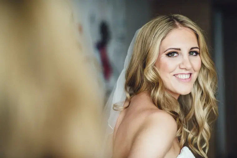 Stephanie smiling over her shoulder in her veil