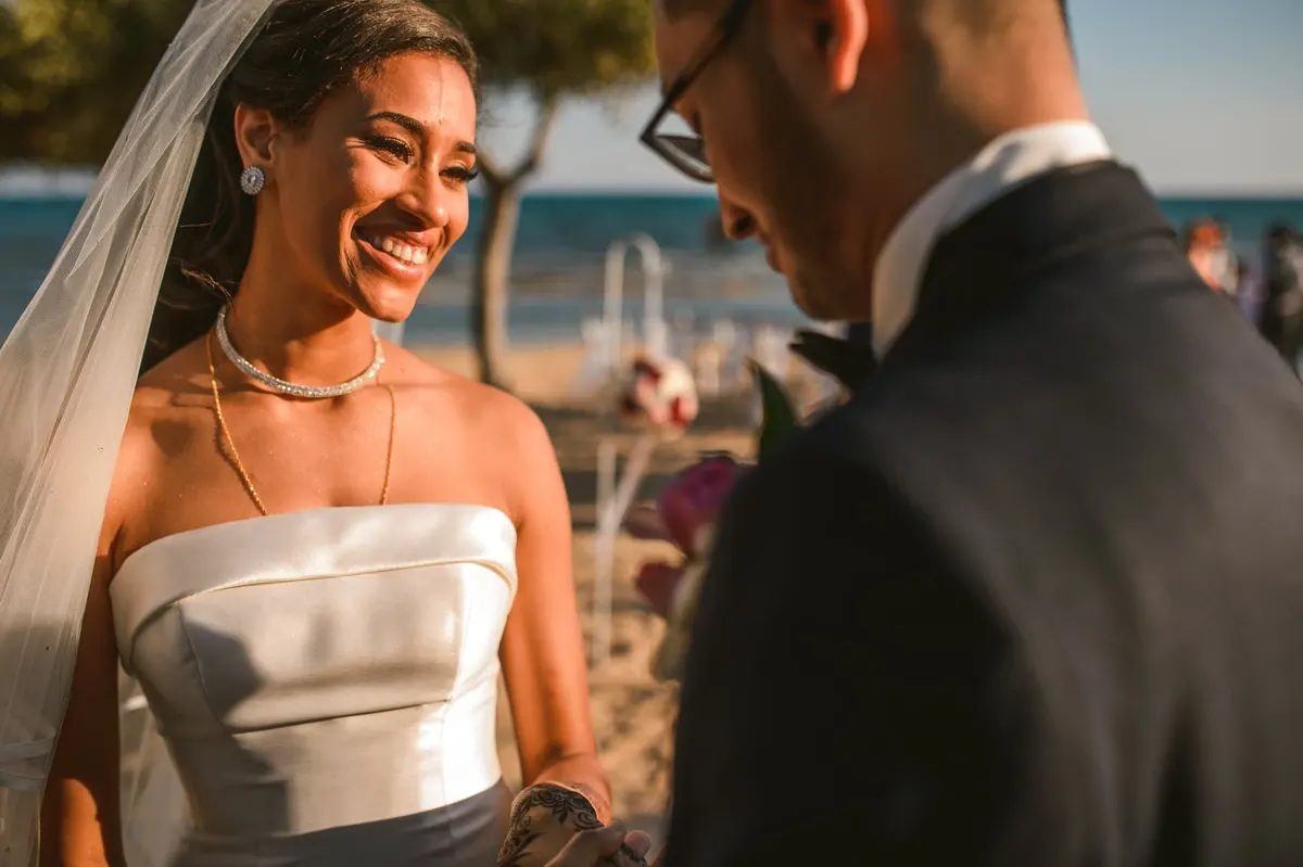 Bride and groom smiling together at their beachfront ceremony
