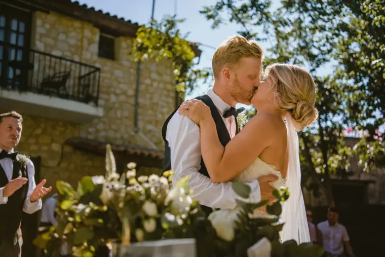 Bride and groom kissing at the end of their ceremony at Vasilias Nikoklis Inn