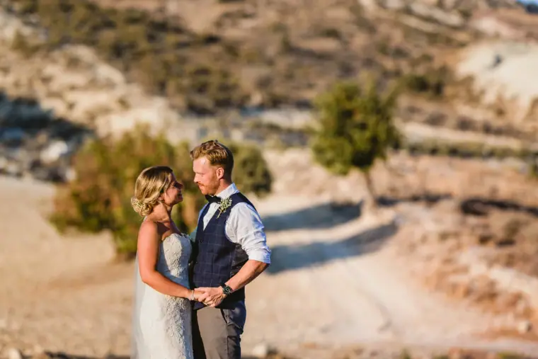 Couple sharing a quiet moment with blurred hills and a winding track behind