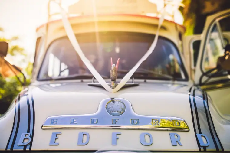 Chrome Bedford badge and white ribbon on the front of the vintage wedding bus