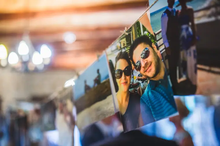 Photos of the couple pegged on a string line across the reception room