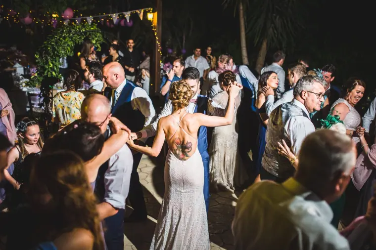 Guests packing the dance floor in the courtyard under bunting