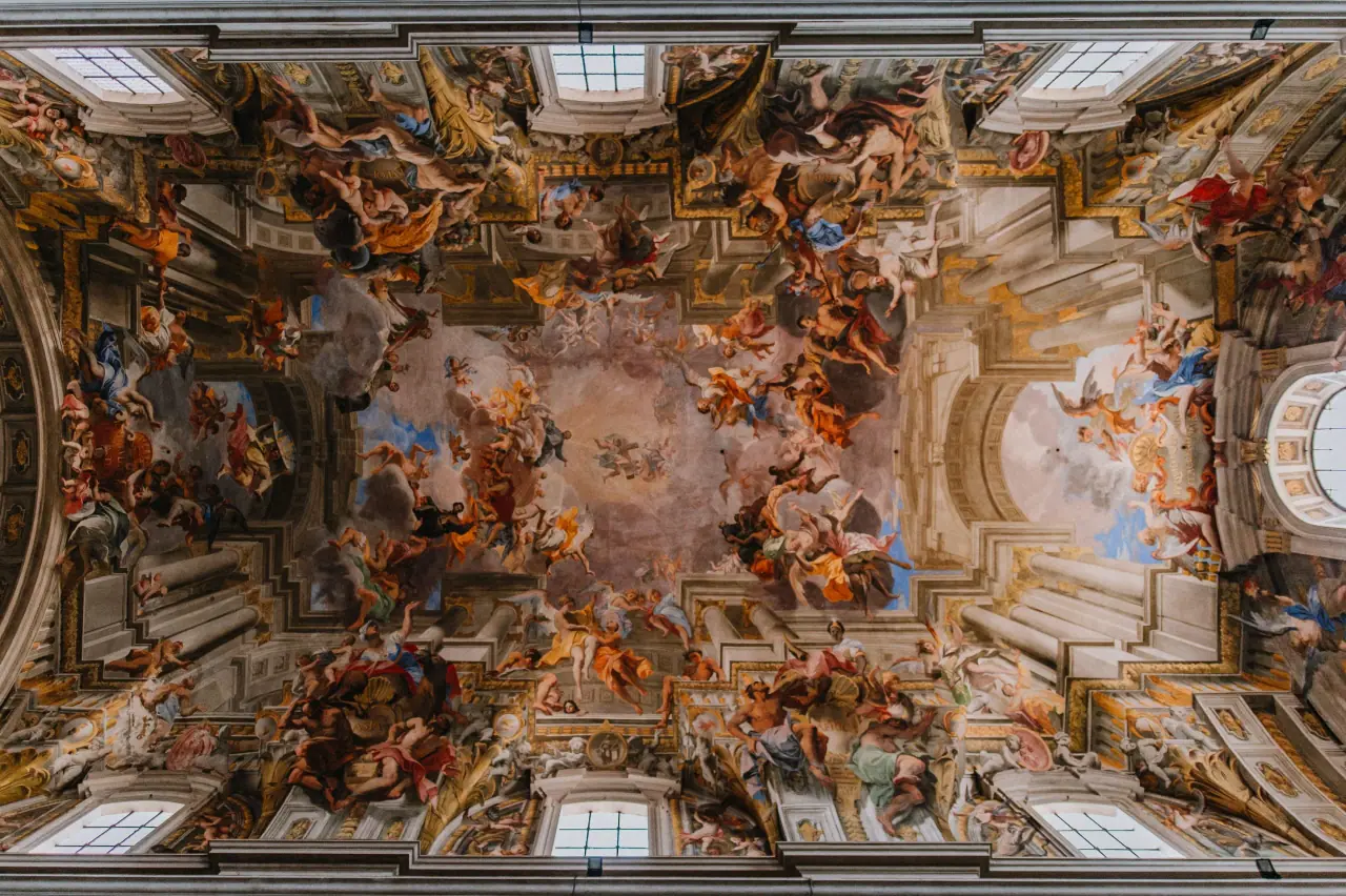Ornate Baroque frescoed ceiling of a church in Rome, seen from directly below