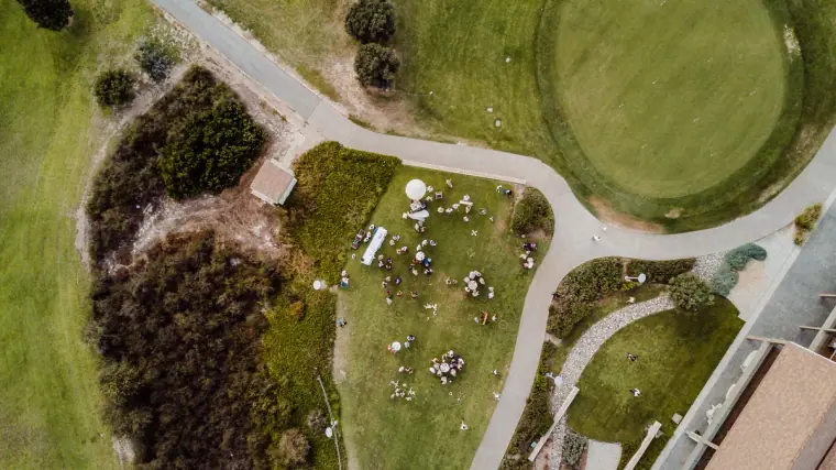 Overhead drone view of guests gathered on the lawn for the drinks reception