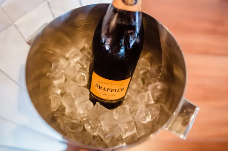 Bottle of Drappier Champagne chilling in an ice bucket, seen from above