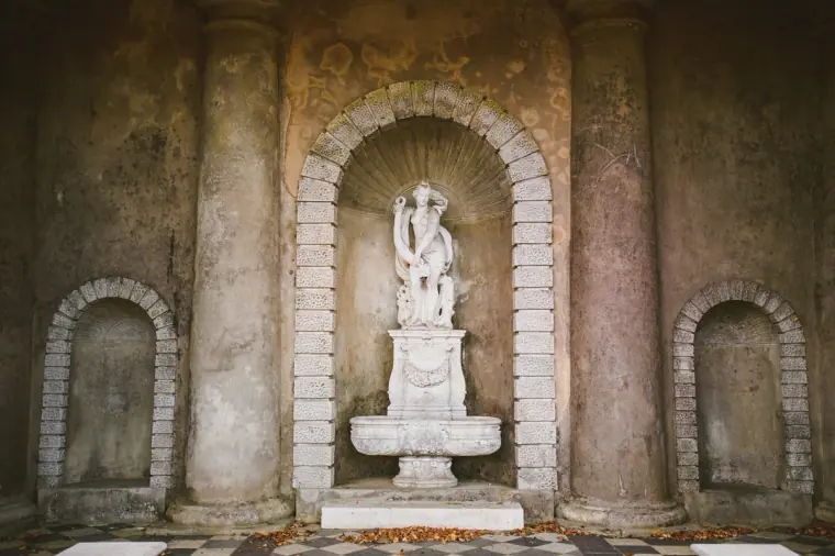 Classical stone grotto with a statue niche in the gardens of Wotton House