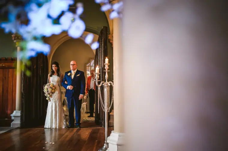 Elina and her father waiting in the doorway before walking down the aisle
