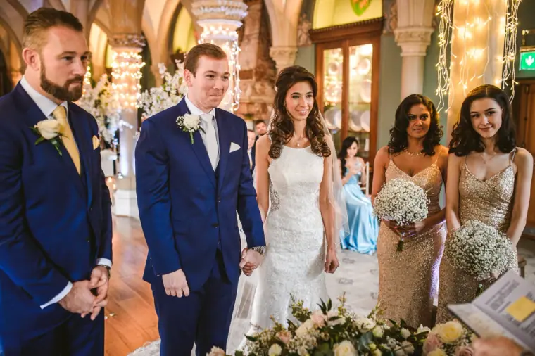 Iain turning to see Elina arrive at the altar, bridesmaids behind her