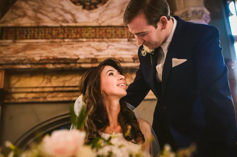 Elina looking up at Iain as she signs the register