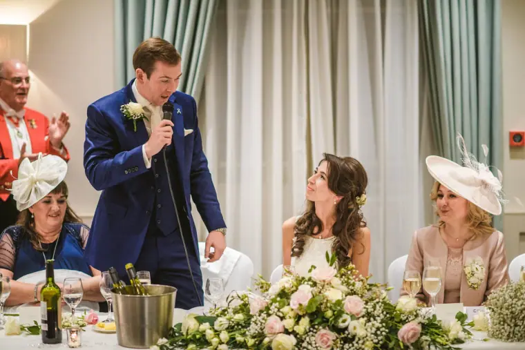 Iain giving his speech with a microphone at the top table